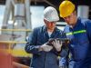 two oil and gas inspectors using the smartflow app to inspect tanks