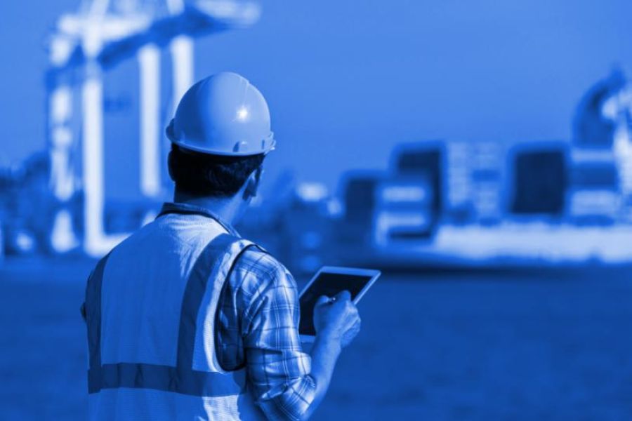 maritime ship inspector holding a tablet with a smart data capture solution