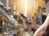 operator holding a phone in a work hall
