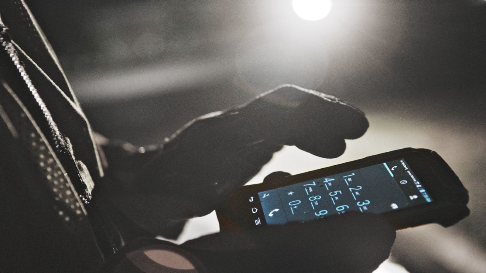 worker holding a rugged phone on which they perform inspections