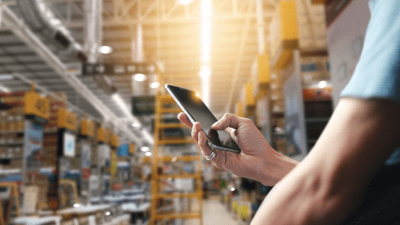operator holding a phone in a work hall