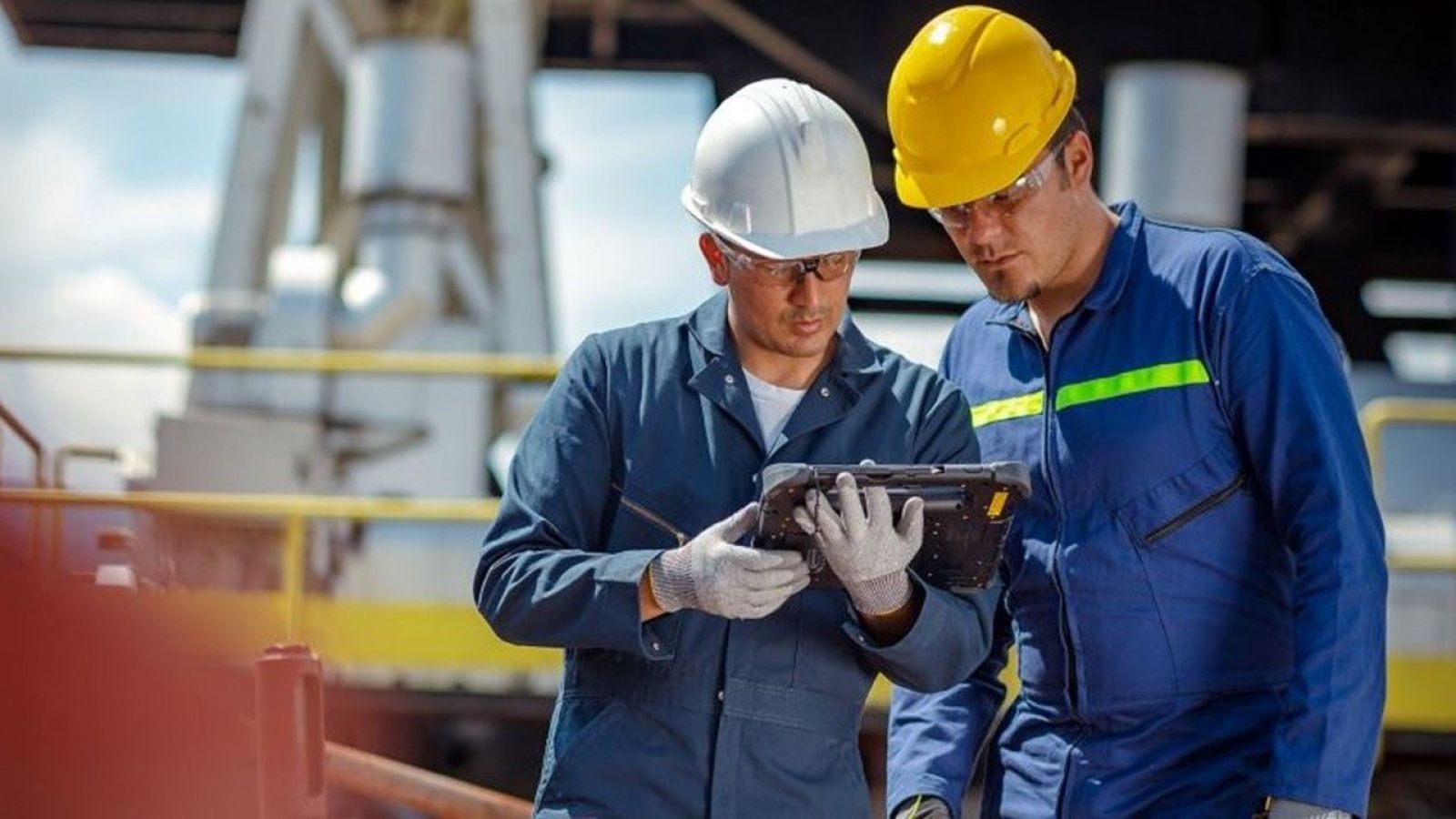 two oil and gas inspectors using the smartflow app to inspect tanks